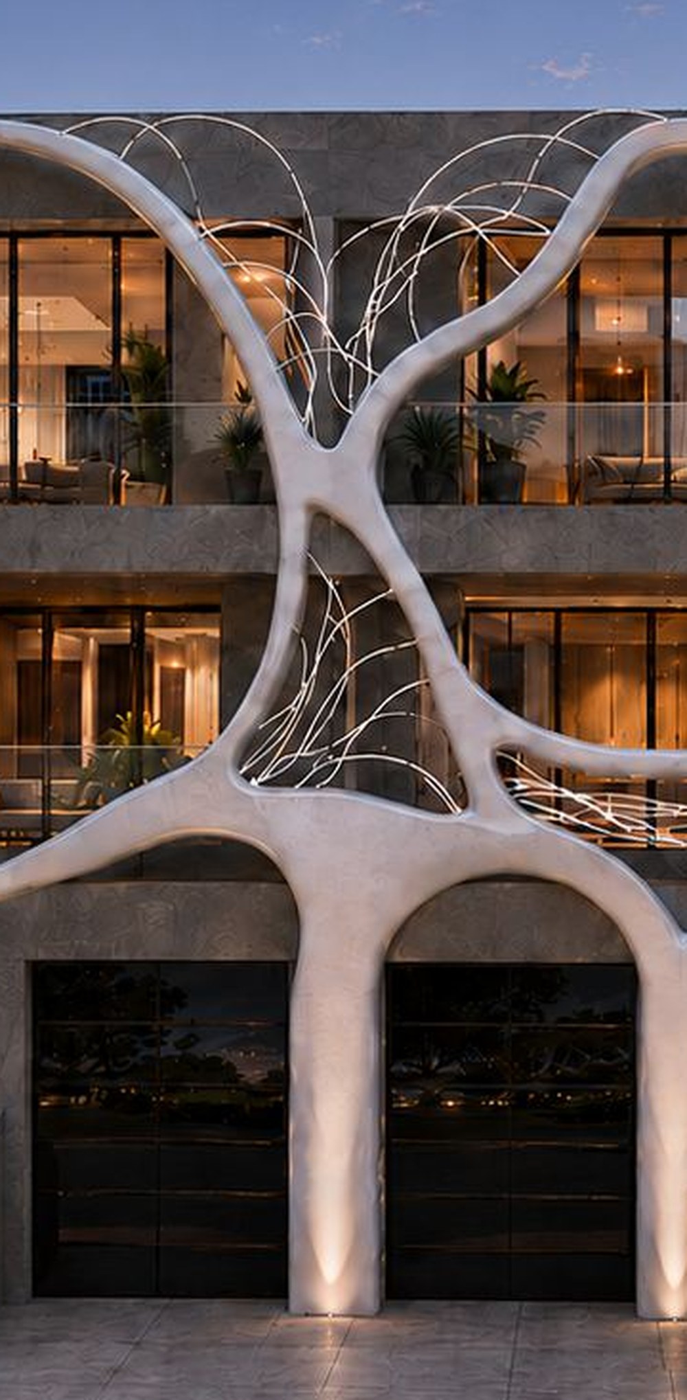 Architectural rendering, detail: the white sculpted form meeting the stone cladding, with the lit filigree spanning behind it.